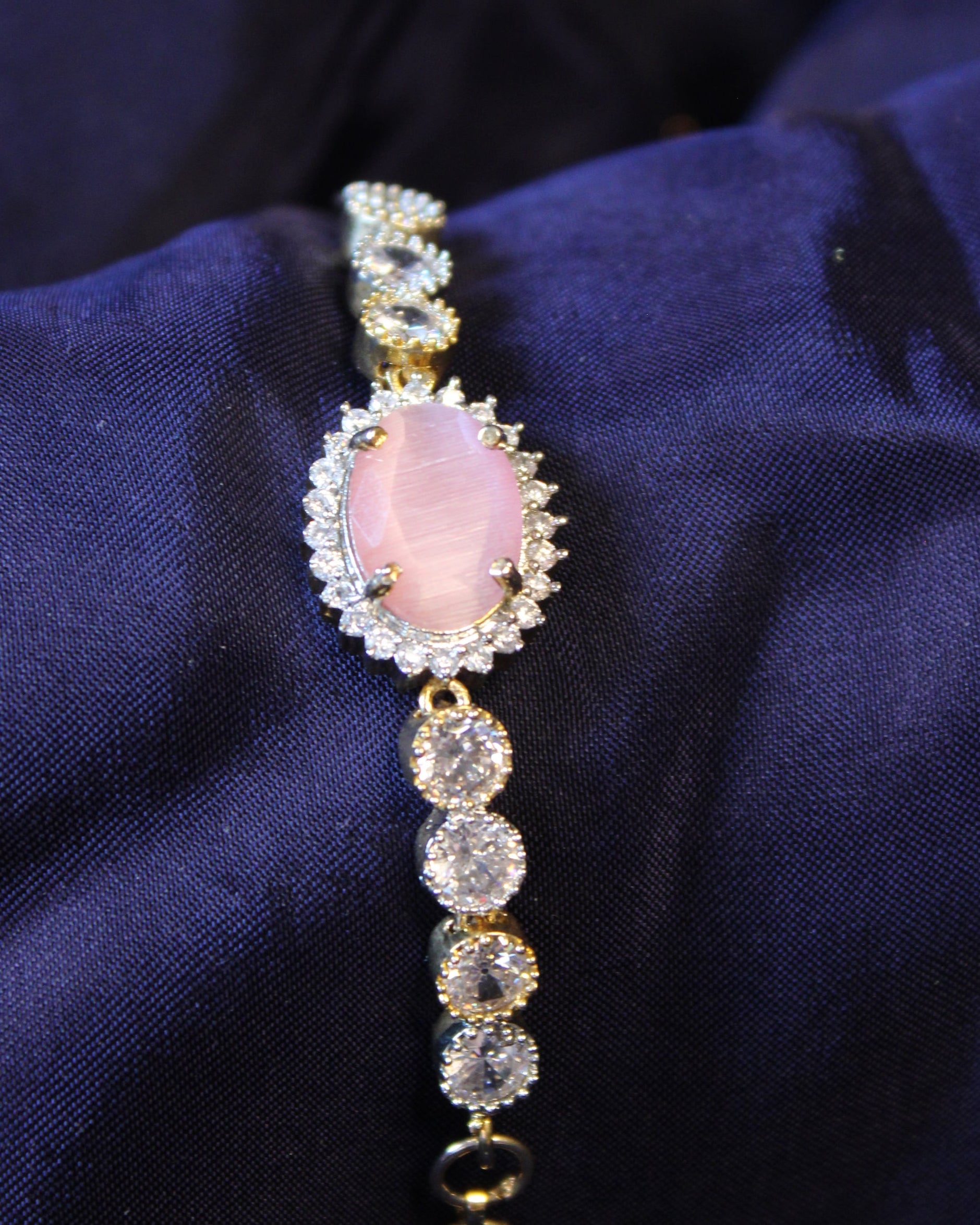 Bracelet with pink gemstone and gold accents 